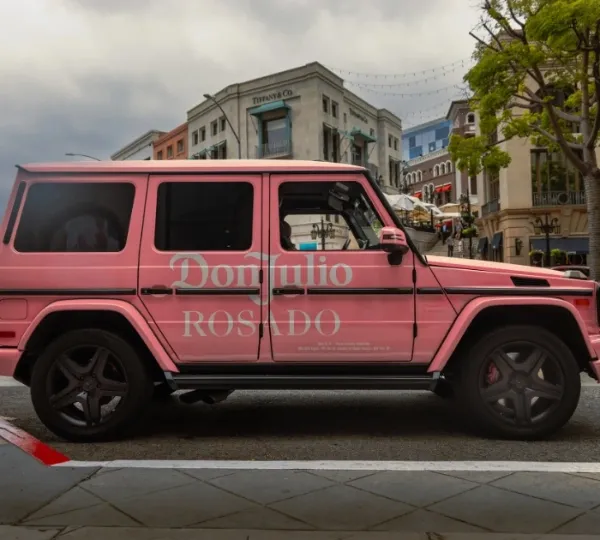 Pink Don Julio branded Mercedes G-Class on a city street